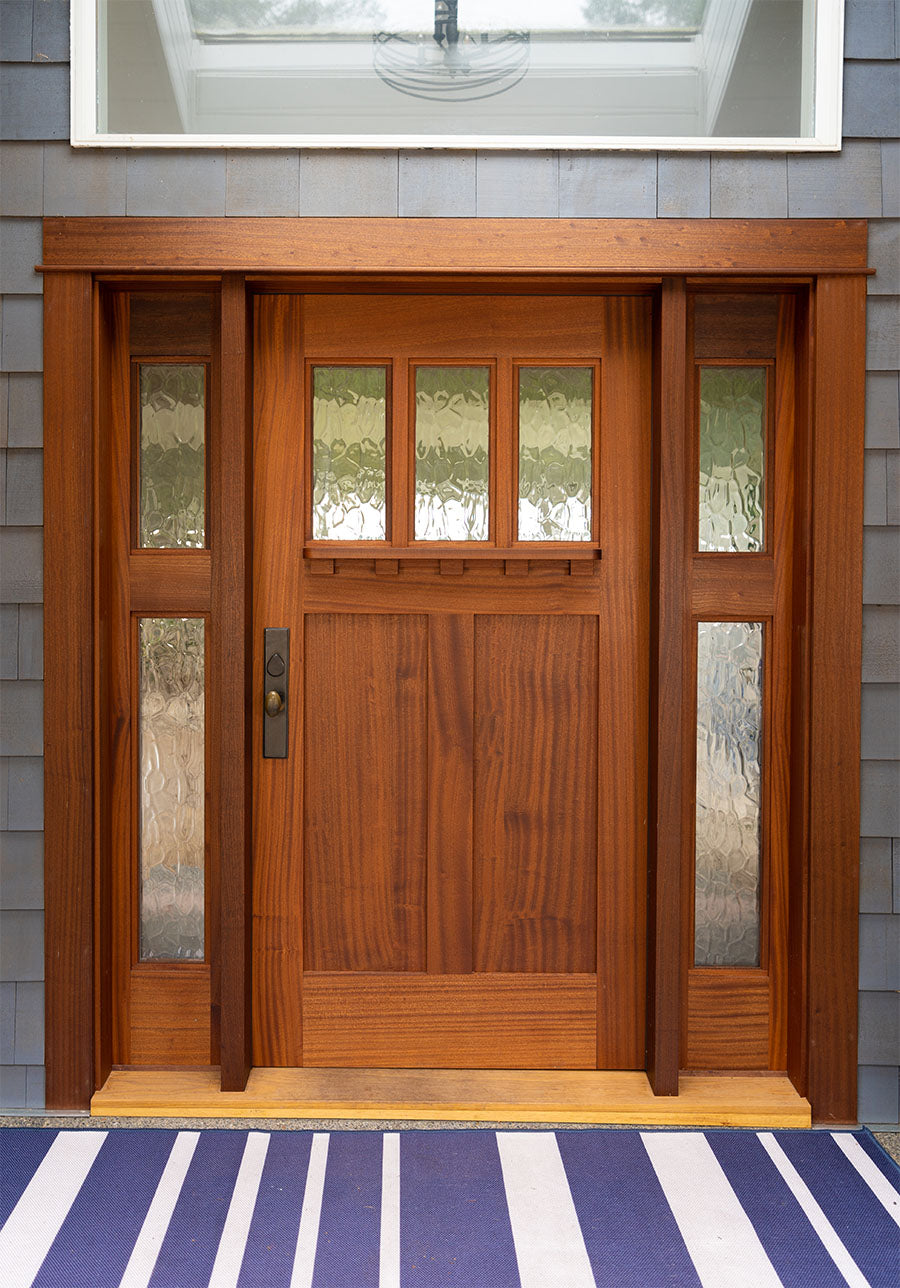 Sapele Mahogany craftsman style entry door with sidelights on  blue house