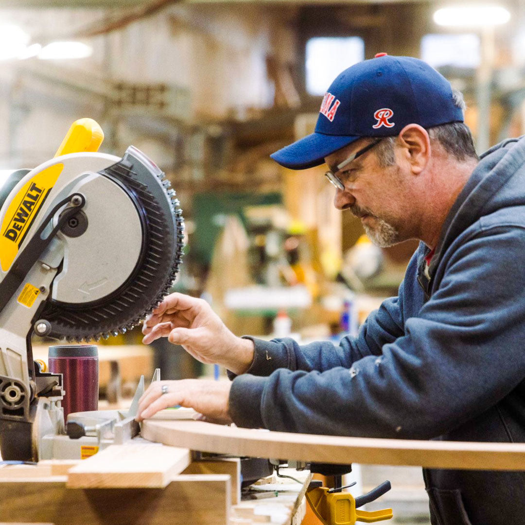 Craftsman cutting wood planks at the wood shop.
