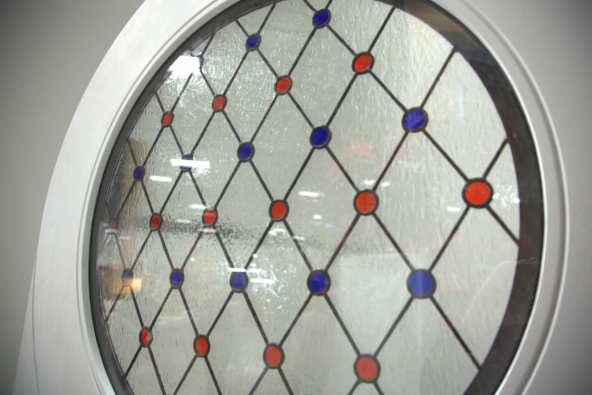 Close up of a white Round Top Door Window inset with Stained Glass Design