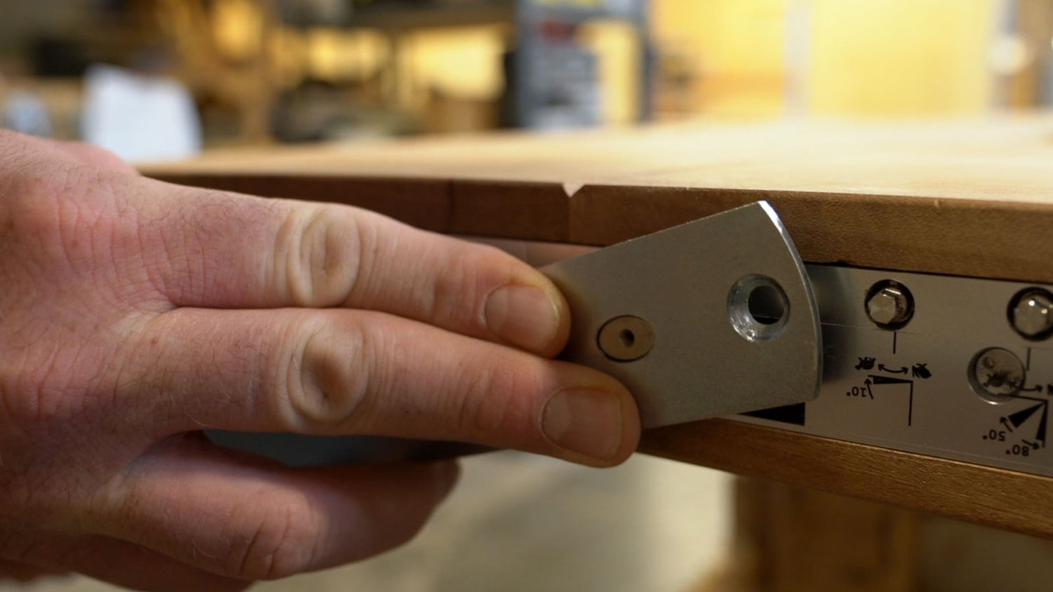 Man's hand adjusting Pivot Door Hardware