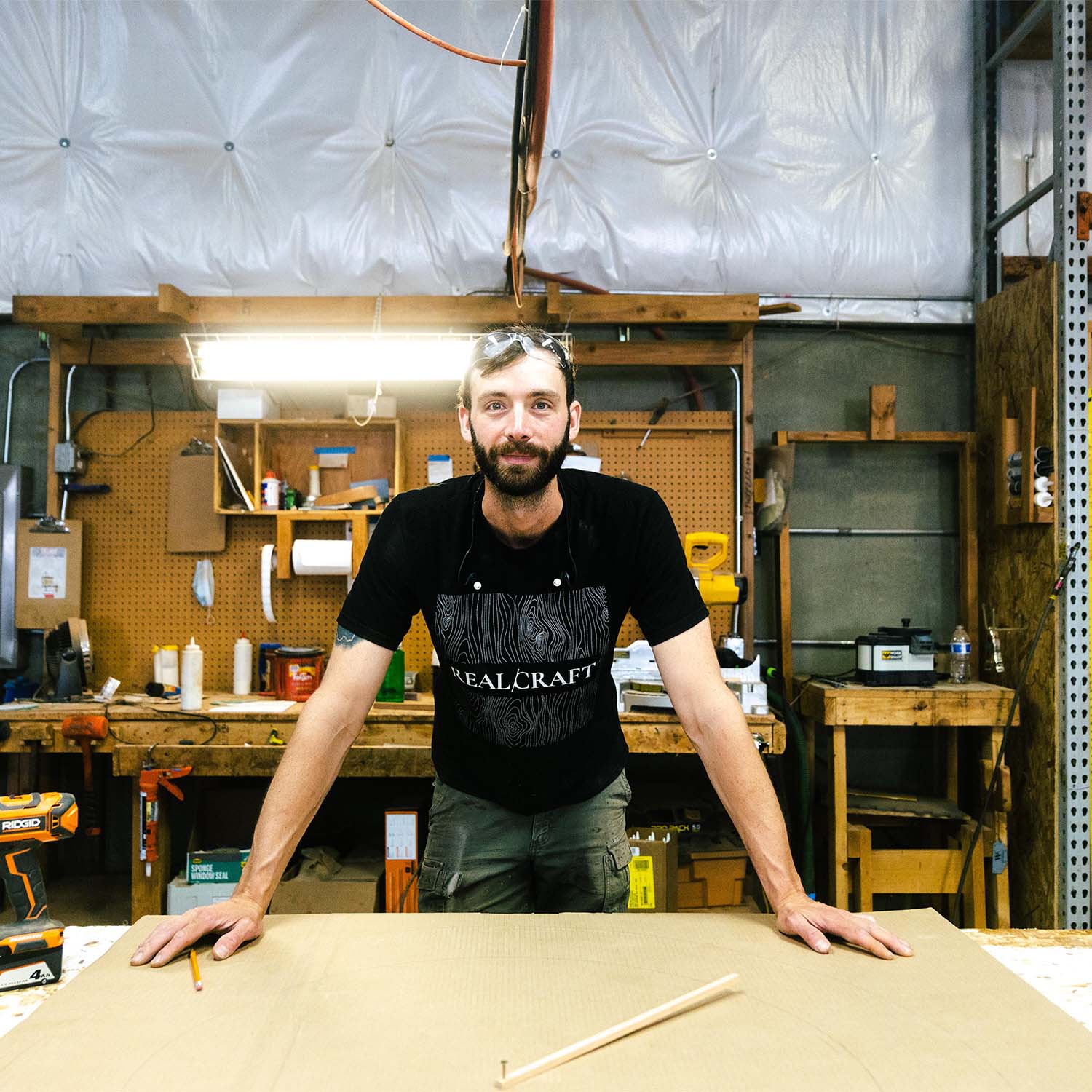 Craftsman at RealCraft's wood shop looking a the camera and smiling.